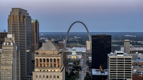 A view of the Gateway Arch and museum at twilight seen across Downtown St. Louis, Missouri Aerial Stock Photos | DXP001_036_0013