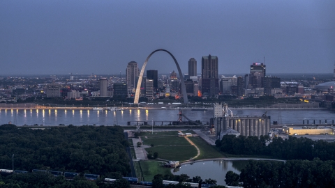 The Gateway Arch at twilight, visible from across the Mississippi River, Downtown St. Louis, Missouri Aerial Stock Photos | DXP001_037_0001