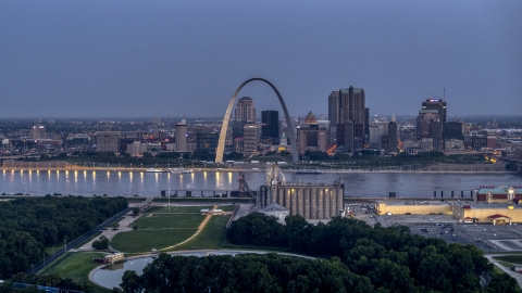 The famous Gateway Arch at twilight, visible from across the Mississippi River, Downtown St. Louis, Missouri Aerial Stock Photos | DXP001_037_0002