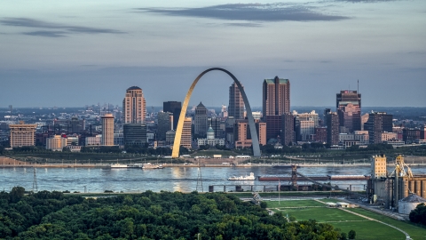 A view of the Gateway Arch by the Mississippi River at sunrise in Downtown St. Louis, Missouri Aerial Stock Photos | DXP001_038_0004