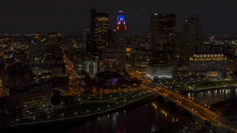 DXP001_088_0013 - Aerial stock photo of The city skyline, and bridge spanning the river at night, Downtown Columbus, Ohio