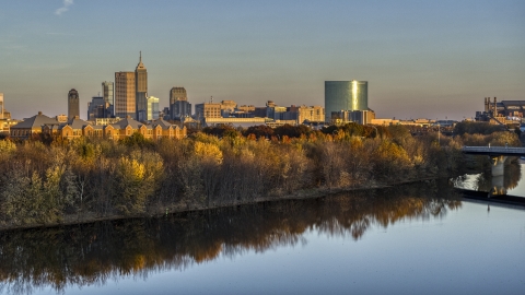 DXP001_092_0008 - Aerial stock photo of The city's skyline at sunset, seen from low over White River, Downtown Indianapolis, Indiana