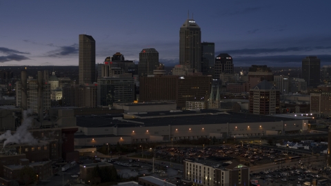 DXP001_093_002 - Aerial stock photo of Smoke stacks at twilight with skyline in background, Downtown Indianapolis, Indiana