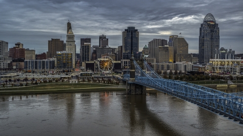 DXP001_097_0009 - Aerial stock photo of A view across the Ohio River near a bridge toward the city skyline at sunset, Downtown Cincinnati, Ohio