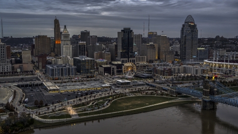 DXP001_097_0011 - Aerial stock photo of The city's downtown skyline and Ferris wheel at sunset from Ohio River, Downtown Cincinnati, Ohio