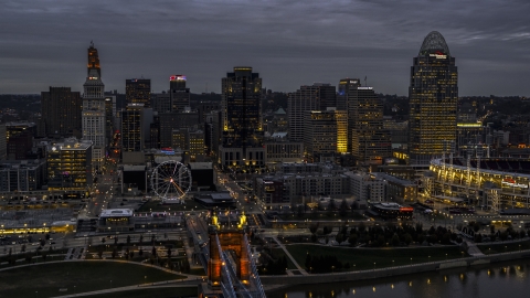 DXP001_098_0002 - Aerial stock photo of City skyline and the end of the bridge lit for twilight, Downtown Cincinnati, Ohio