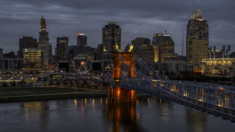 DXP001_098_0006 - Aerial stock photo of A view of the bridge and city skyline at twilight from the river, Downtown Cincinnati, Ohio