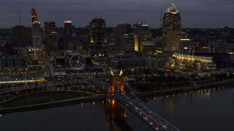 DXP001_098_0009 - Aerial stock photo of A view of the lights of city skyline and bridge at twilight, seen from river, Downtown Cincinnati, Ohio