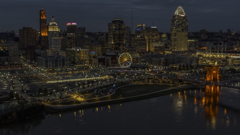 DXP001_098_0014 - Aerial stock photo of Ferris wheel and skyscrapers at twilight seen from the river, Downtown Cincinnati, Ohio