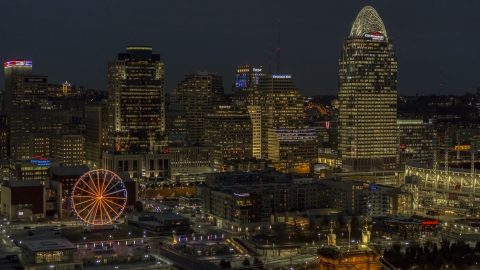 DXP001_098_0018 - Aerial stock photo of Tall skyscrapers and Ferris wheel at night in Downtown Cincinnati, Ohio