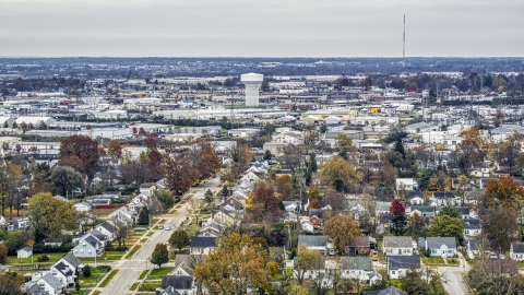 Homes with view of a water tower surrounded by warehouses in Lexington, Kentucky Aerial Stock Photos | DXP001_099_0017