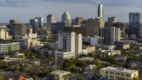 DXP002_104_0015 - Aerial stock photo of A courthouse near office buildings and skyscrapers at sunset in Downtown Austin, Texas