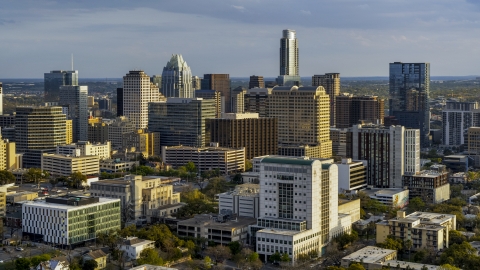 DXP002_104_0017 - Aerial stock photo of Criminal courthouse near office buildings and skyscrapers at sunset in Downtown Austin, Texas