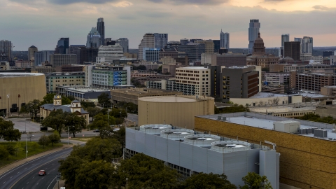 DXP002_105_0009 - Aerial stock photo of A view of hospital, skyscrapers and capitol dome at sunset in Downtown Austin, Texas