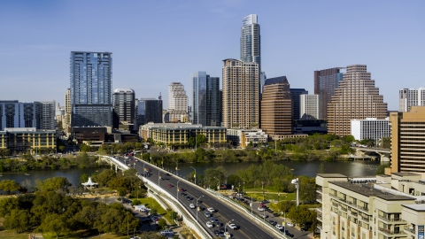 DXP002_109_0001 - Aerial stock photo of The city's skyline across Lady Bird Lake seen from bridge, Downtown Austin, Texas