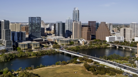 DXP002_109_0003 - Aerial stock photo of The city's skyline across Lady Bird Lake, seen from park near bridge, Downtown Austin, Texas