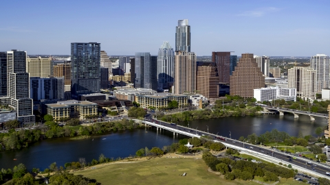 DXP002_109_0004 - Aerial stock photo of The city's skyline on the other side of Lady Bird Lake, seen from park by bridge, Downtown Austin, Texas