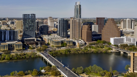 DXP002_109_0006 - Aerial stock photo of Skyscrapers in the city's skyline across Lady Bird Lake seen from a bridge in Downtown Austin, Texas