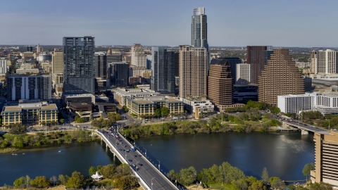 DXP002_109_0007 - Aerial stock photo of A view of skyscrapers of the city's skyline across Lady Bird Lake seen from a bridge, Downtown Austin, Texas