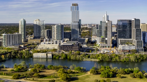 DXP002_109_0009 - Aerial stock photo of A modern skyscraper on the opposite side of Lady Bird Lake, Downtown Austin, Texas