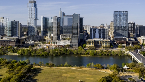 DXP002_109_0013 - Aerial stock photo of The Northshore skyscraper on the other side of Lady Bird Lake, seen from a park, Downtown Austin, Texas