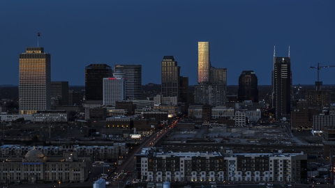 Towering skyscrapers reflecting light in the city skyline at twilight before descent, Downtown Nashville, Tennessee Aerial Stock Photos | DXP002_115_0008