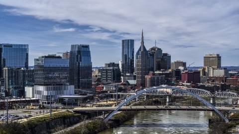 Office high-rise and skyscrapers seen from river and bridge in Downtown Nashville, Tennessee Aerial Stock Photos | DXP002_116_0010