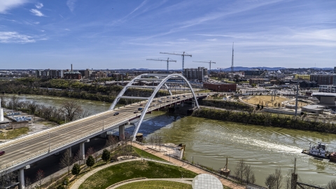 A barge sailing away from a bridge in Nashville, Tennessee Aerial Stock Photos | DXP002_117_0003