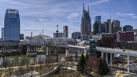 DXP002_117_0008 - Aerial stock photo of A pedestrian bridge with view of Broadway across the Cumberland River, Downtown Nashville, Tennessee