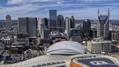 DXP002_117_0010 - Aerial stock photo of A view of the city's skyline behind the arena, Downtown Nashville, Tennessee