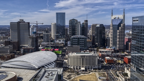 DXP002_117_0011 - Aerial stock photo of The city's skyline behind arena and hotel, Downtown Nashville, Tennessee