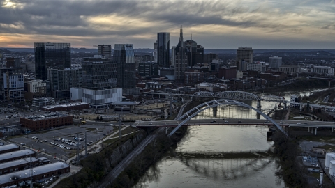 The skyline and a bridge over the Cumberland River at sunset, Downtown Nashville, Tennessee Aerial Stock Photos | DXP002_119_0015