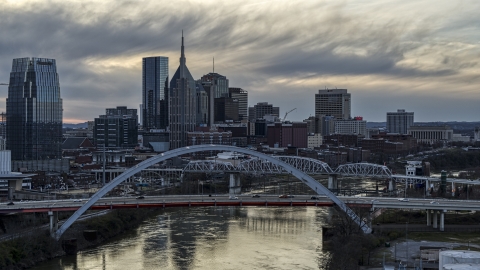 Riverfront skyline seen from a bridge and Cumberland River at sunset, Downtown Nashville, Tennessee Aerial Stock Photos | DXP002_120_0003