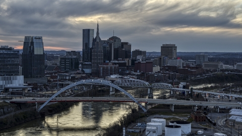 DXP002_120_0007 - Aerial stock photo of The riverfront skyline, two bridges, and the Cumberland River at sunset, Downtown Nashville, Tennessee