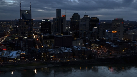 A group of skyscrapers at twilight on the other side of the river, Downtown Nashville, Tennessee Aerial Stock Photos | DXP002_120_0018