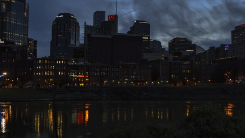 Skyscrapers at twilight seen from low over the river, Downtown Nashville, Tennessee Aerial Stock Photos | DXP002_120_0020