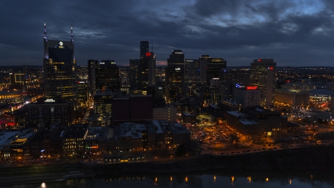 AT&T Building and the city's skyline at twilight, seen from Cumberland River, Downtown Nashville, Tennessee Aerial Stock Photos | DXP002_121_0003