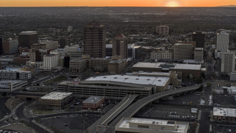 Office high-rises and convention center near office tower and shorter hotel tower at sunset, Downtown Albuquerque, New Mexico Aerial Stock Photos | DXP002_122_0010