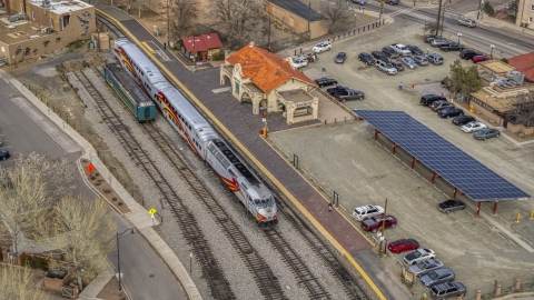 DXP002_130_0008 - Aerial stock photo of A view of a passenger train at the station in Santa Fe, New Mexico, tilt to top of the train