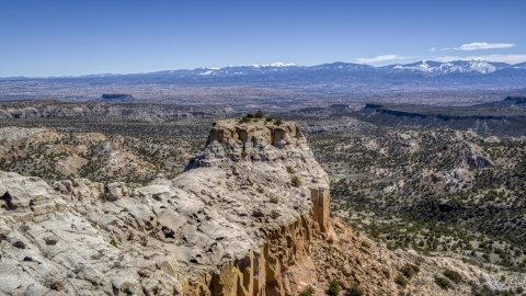 The end of a desert mesa with a view of distance mountains in New Mexico Aerial Stock Photos | DXP002_133_0010