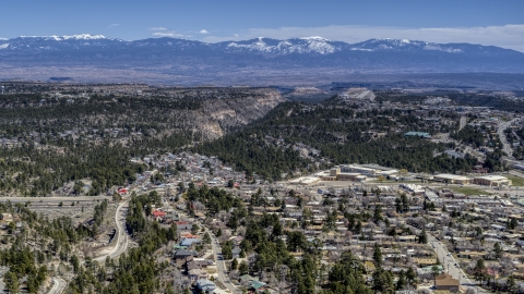 DXP002_134_0002 - Aerial stock photo of Distant mountains seen from neighborhoods near mesas and canyons in Los Alamos, New Mexico