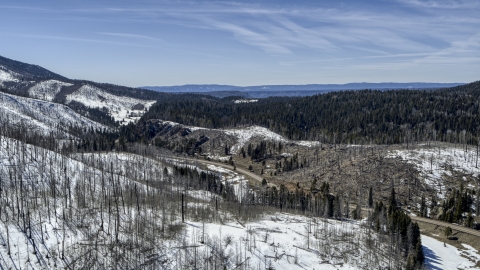 Black cars on a winding road by snowy mountains, New Mexico Aerial Stock Photos | DXP002_134_0017