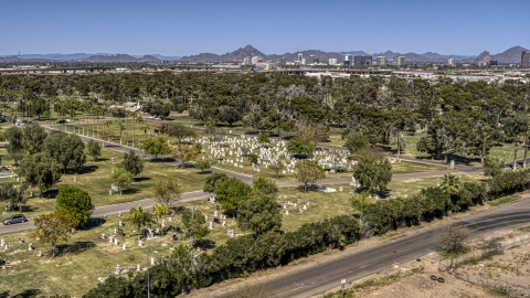 DXP002_137_0001 - Aerial stock photo of Green lawns, trees and grave markers at a cemetery in Phoenix, Arizona