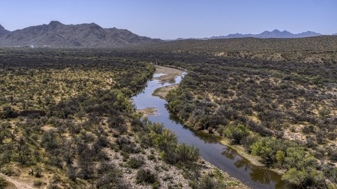 DXP002_141_0001 - Aerial stock photo of Horses at a shallow river through the desert