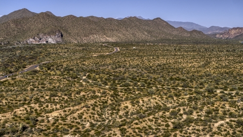 DXP002_141_0018 - Aerial stock photo of A desert road near mountains