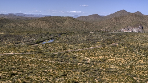 DXP002_141_0021 - Aerial stock photo of A desert road with light traffic, and mountains in the background