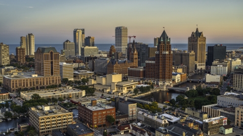 DXP002_150_0004 - Aerial stock photo of A view of city buildings and skyscrapers seen from Milwaukee River at twilight, Downtown Milwaukee, Wisconsin