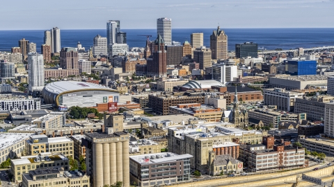 DXP002_152_0003 - Aerial stock photo of The city's skyline and arena in Downtown Milwaukee, Wisconsin, seen from industrial buildings