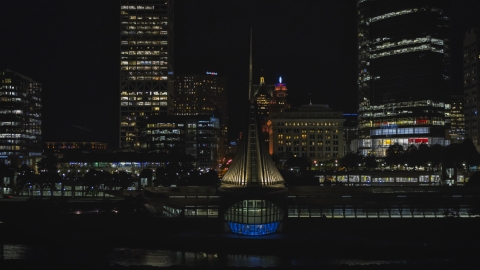 DXP002_157_0008 - Aerial stock photo of The lakefront museum near skyscrapers at night, Downtown Milwaukee, Wisconsin