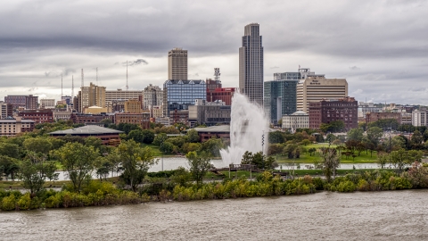 DXP002_169_0006 - Aerial stock photo of A fountain and riverfront park with view of skyline, Downtown Omaha, Nebraska